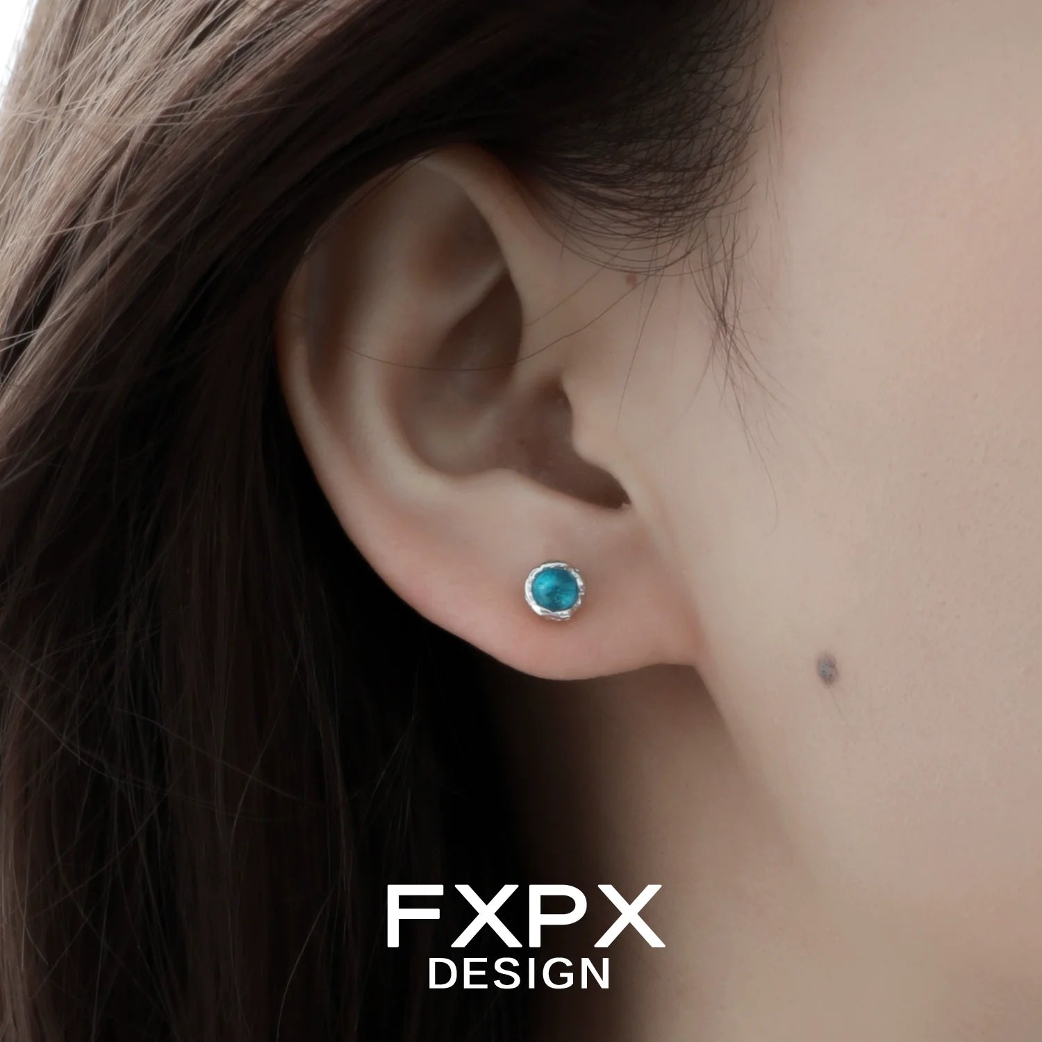 Turquoise blue screw stud earrings displayed on a model's ear for a stylish look