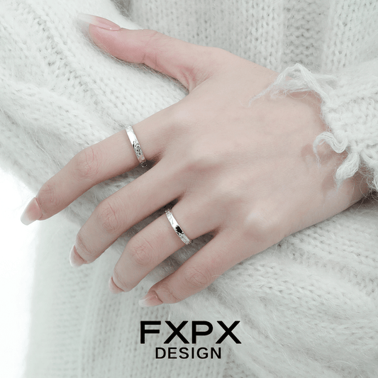 Elegant FXPX unique couple rings in silver worn on a hand with a cozy sweater