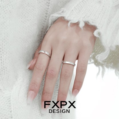 Unique couple rings by FXPX displayed on a hand wearing cozy white knit sweater