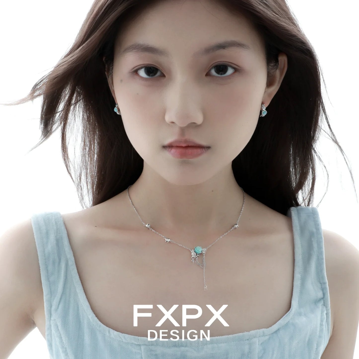 FXPX vintage blue rose earrings showcased on a model with a light blue outfit