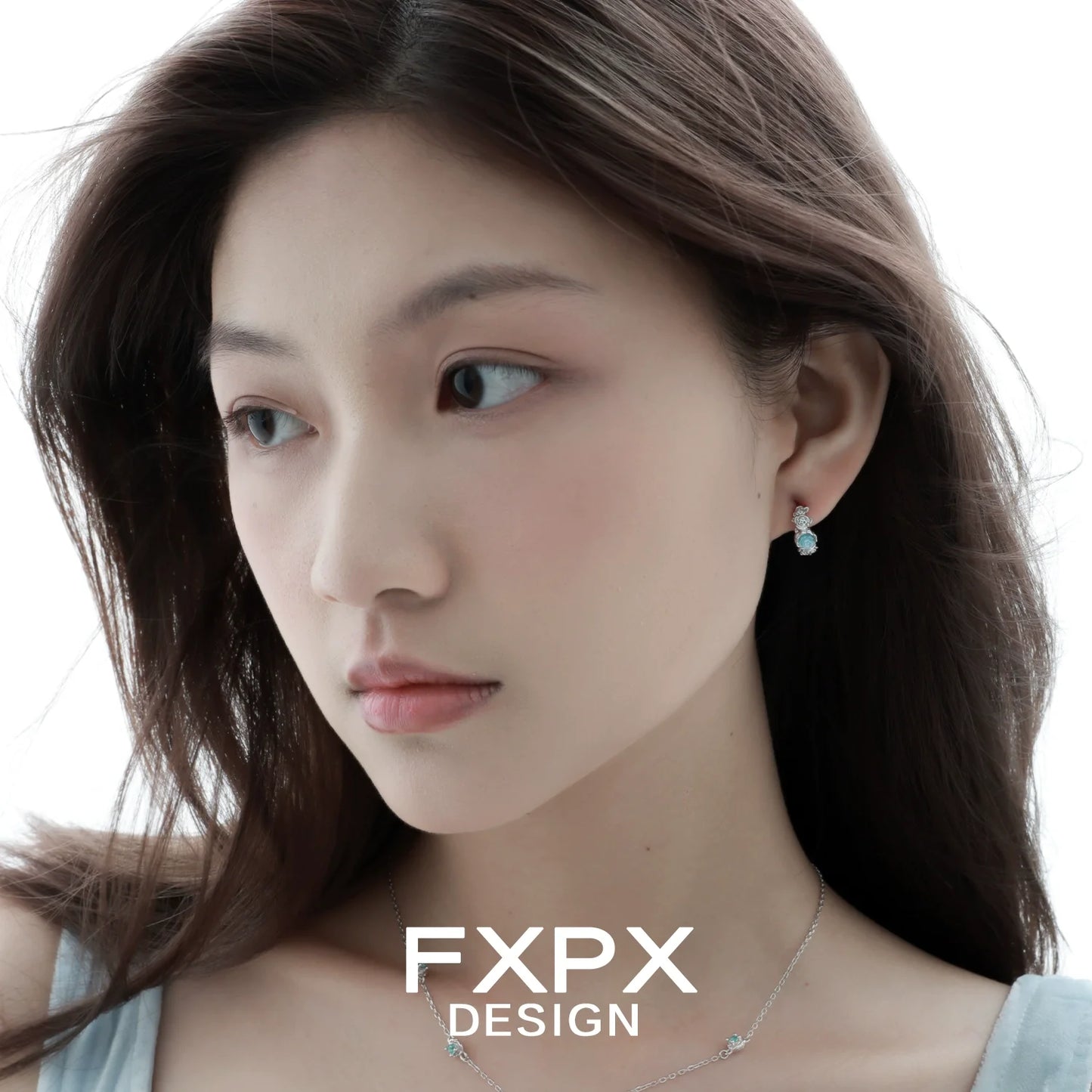 Elegant vintage blue rose earrings showcased on a model with flowing hair