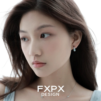 Elegant vintage blue rose earrings showcased on a model with flowing hair