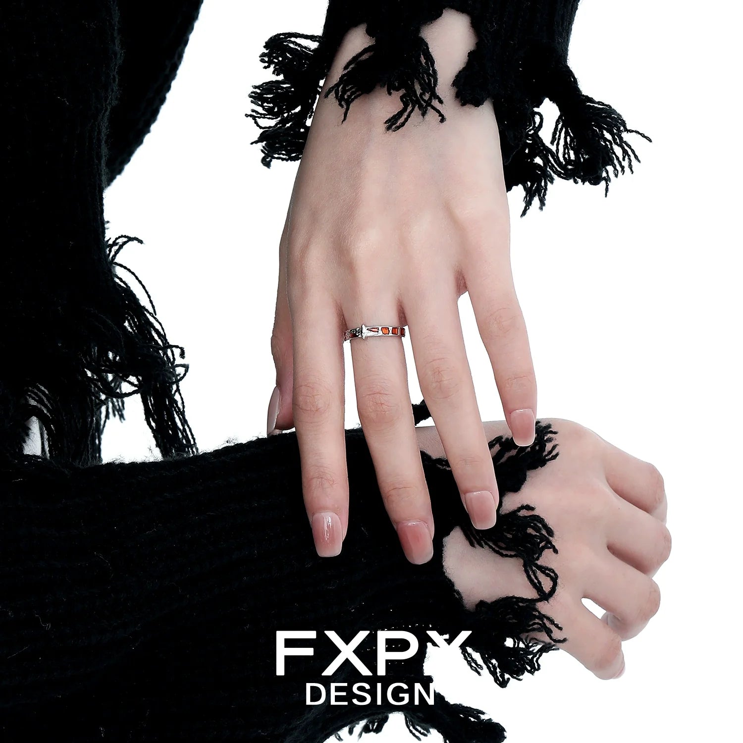 Stylish vintage checkerboard star ring showcased on a model's hand with black fringed sweater