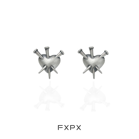 Vintage punk silver earrings featuring a heart design with spikes for a bold fashion statement