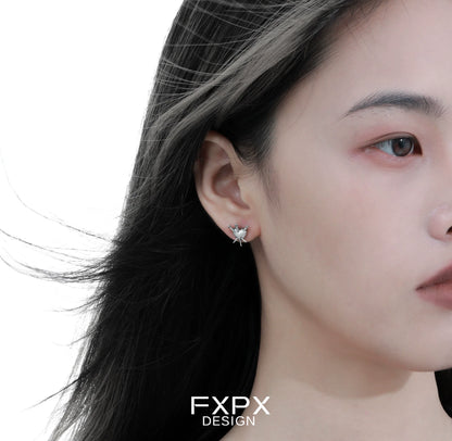 Close-up of vintage punk silver earrings worn by a model showcasing edgy style and unique design