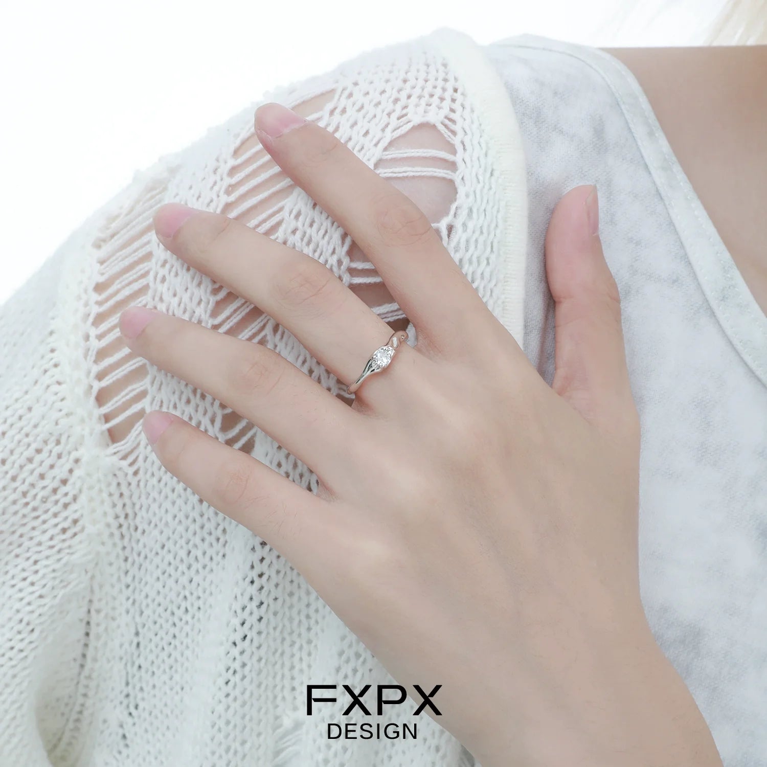 Elegant FXPX white zircon ring with a delicate twisted design on a model's hand