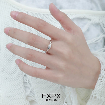 Elegant FXPX white zircon ring displayed on a woman's hand, showcasing intricate design and sparkle