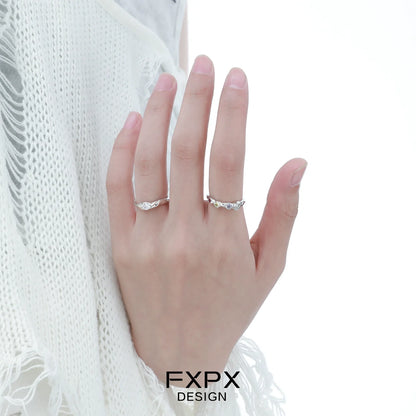 Elegant FXPX white zircon ring displayed on a hand with a soft knit background