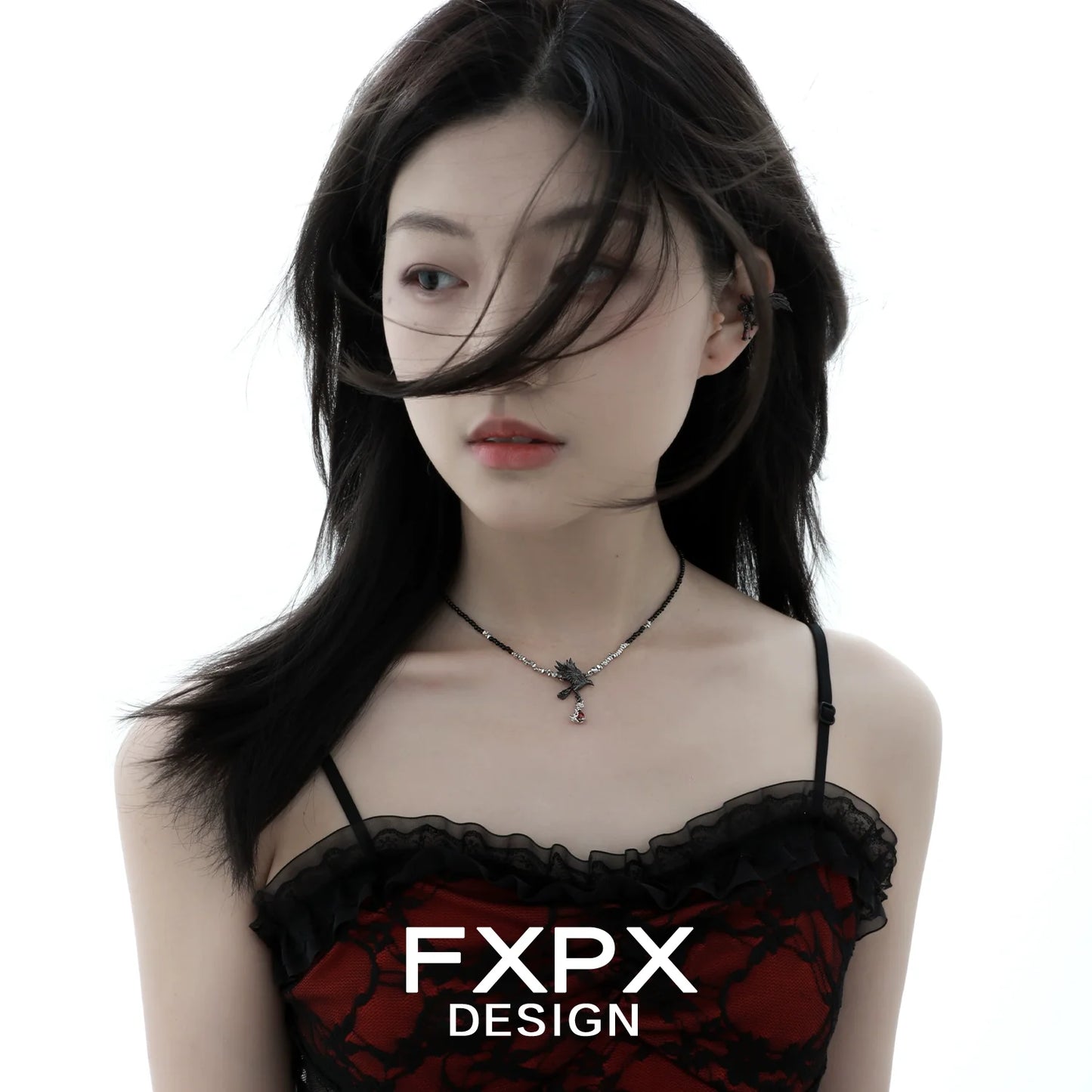 Y2K crow pendant necklace featured on a model wearing a stylish outfit against a white background