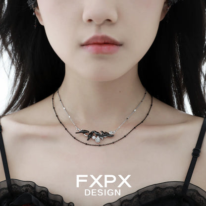 Y2K crow pendant necklace by FXPX showcased on a model with a chic outfit