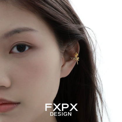 Y2K golden rose ear cuff worn stylishly on a model's ear showcasing its unique design