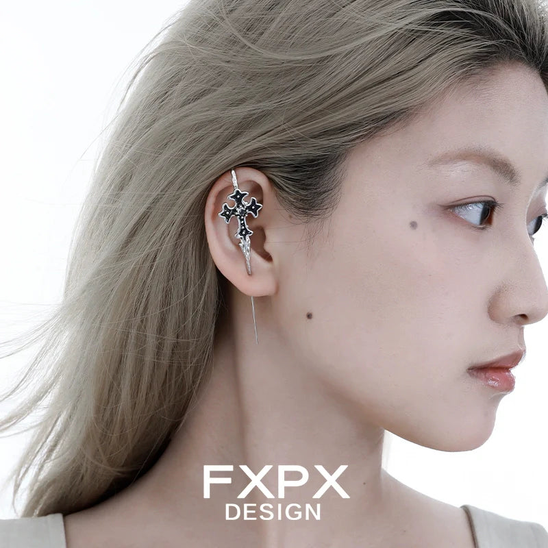 FXPX Y2K gothic cross ear needle with unique design, worn on a model's ear