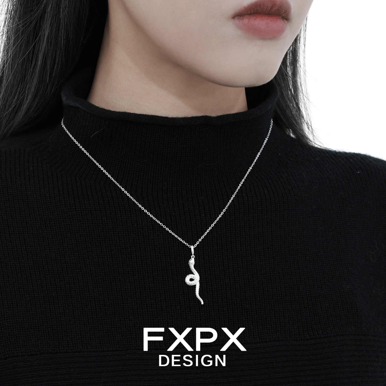 Y2K silver snake necklace elegantly worn on a model's neck with a black sweater