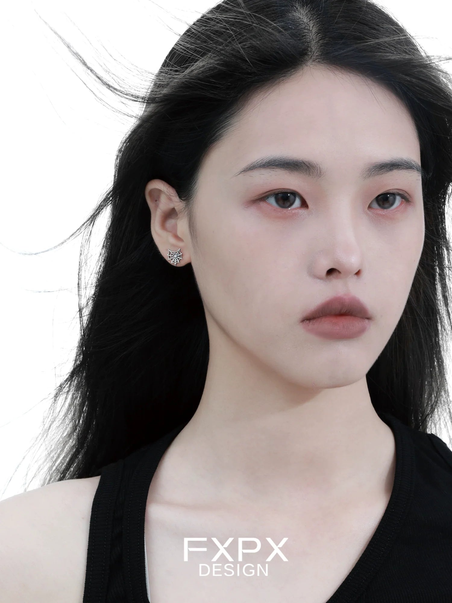 FXPX Y2K spider web earrings showcased on a model with flowing hair and a neutral expression