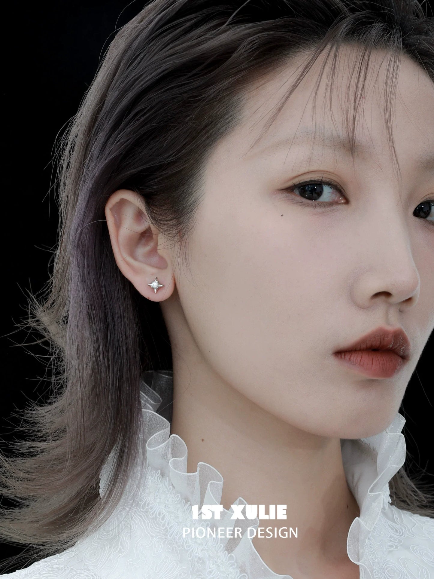 Elegant model wearing galaxy pearl stud earrings with a chic hairstyle and stylish outfit