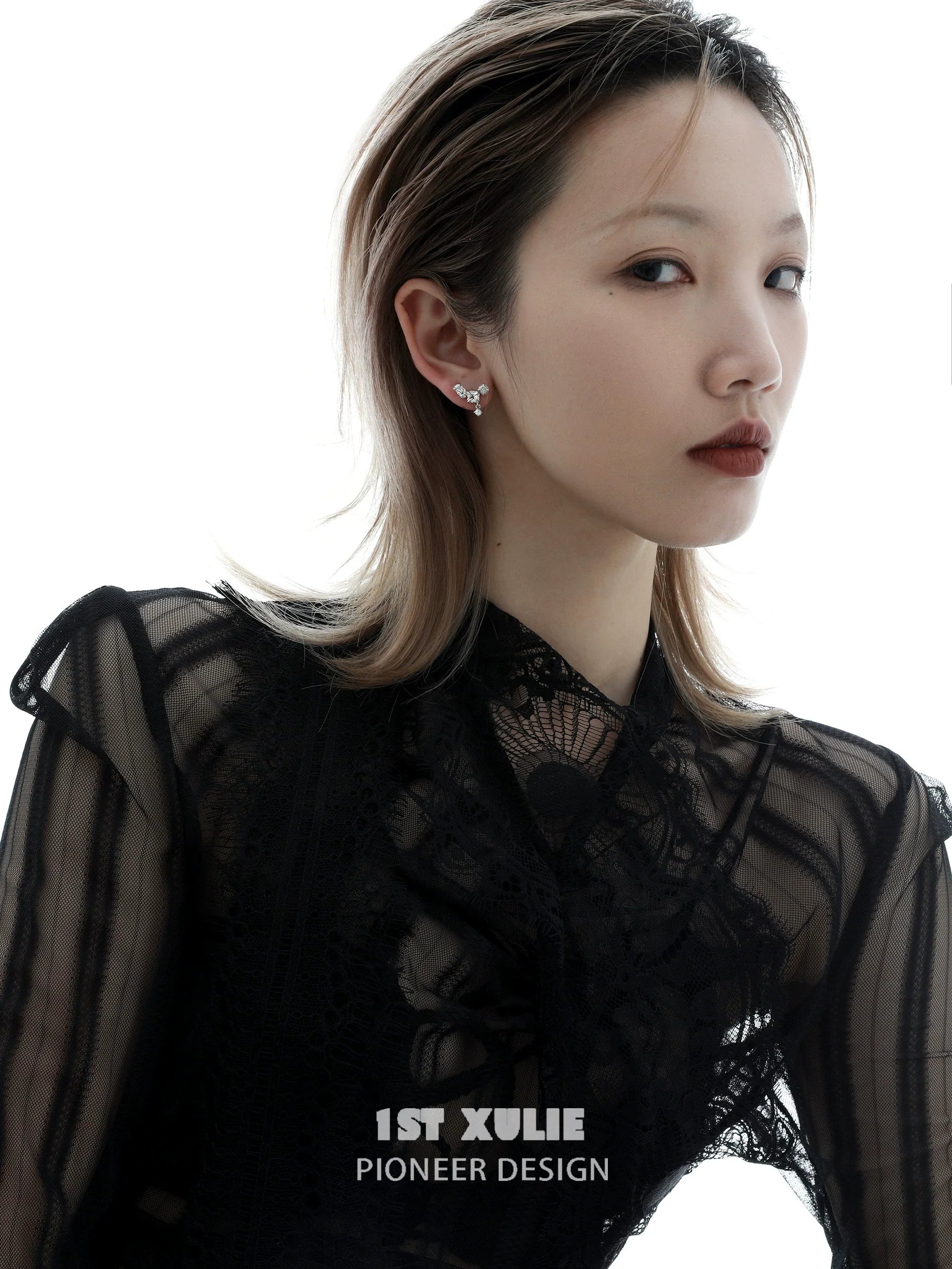 Elegant model showcasing geometric silver earrings with a modern design and stylish appeal