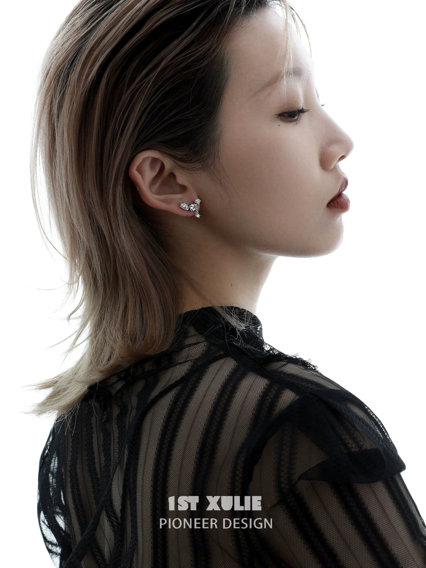 Elegant geometric silver earrings displayed on a model showcasing modern design and style