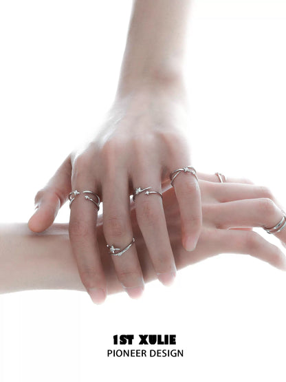 Stylish geometric silver ring worn on multiple fingers for modern fashion enthusiasts