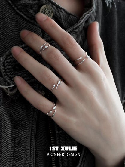 Stylish geometric silver ring set displayed on a hand with three minimalist designs for modern jewelry lovers
