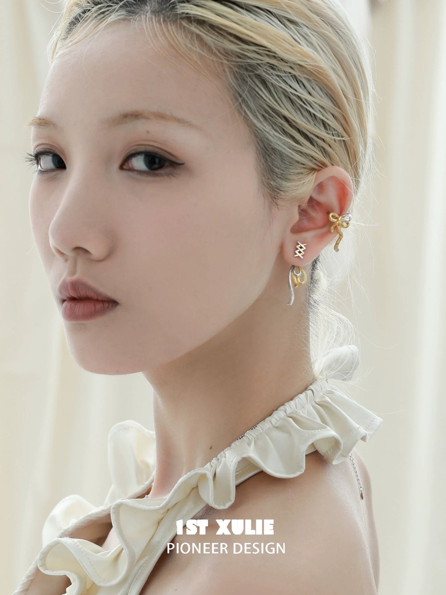 Elegant gold bow ear cuff designed by 1ST XULIE, enhancing the ear with unique style