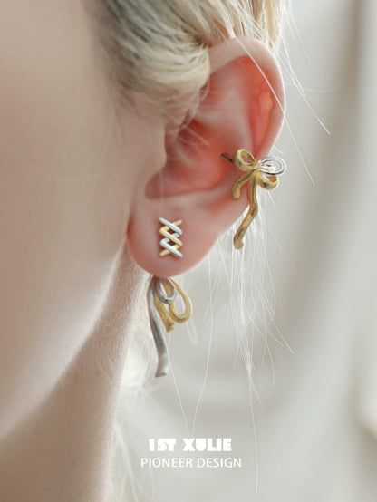 Elegant gold bow ear cuff from 1STXULIE, showcasing a stylish and unique design for modern accessories