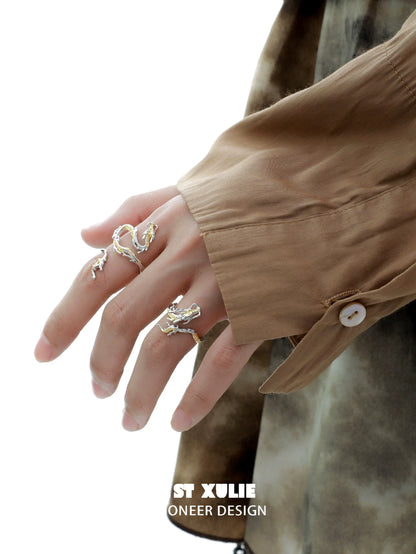 Gold dragon wrap silver ring elegantly displayed on a hand with stylish attire