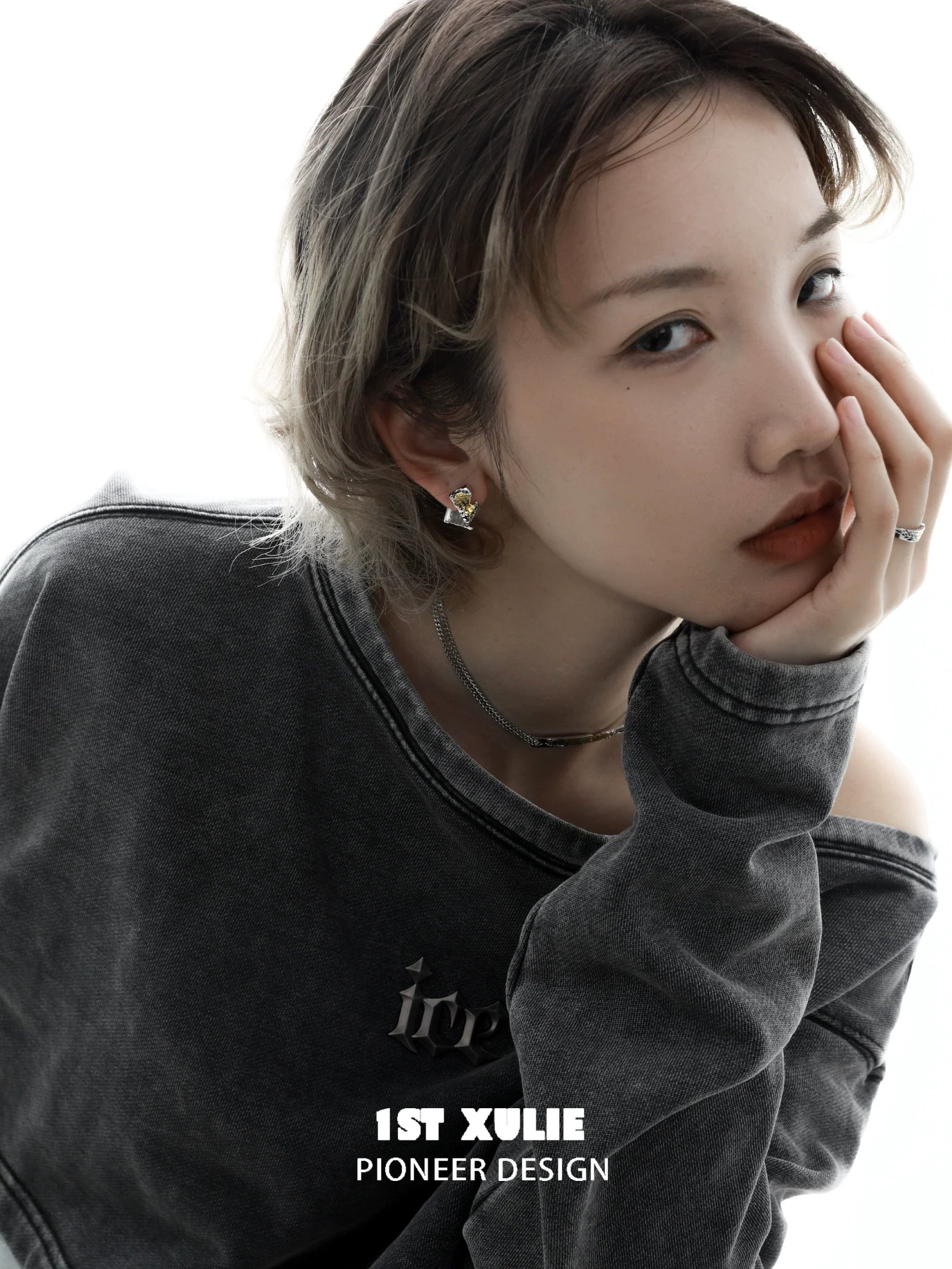 Stylish gold map earrings for women featured on a model in a casual outfit