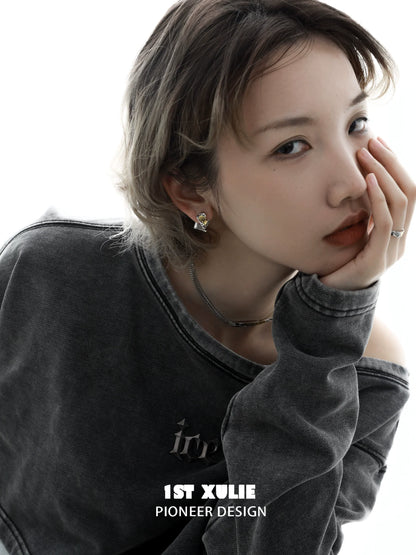Stylish gold map earrings for women featured on a model in a casual outfit