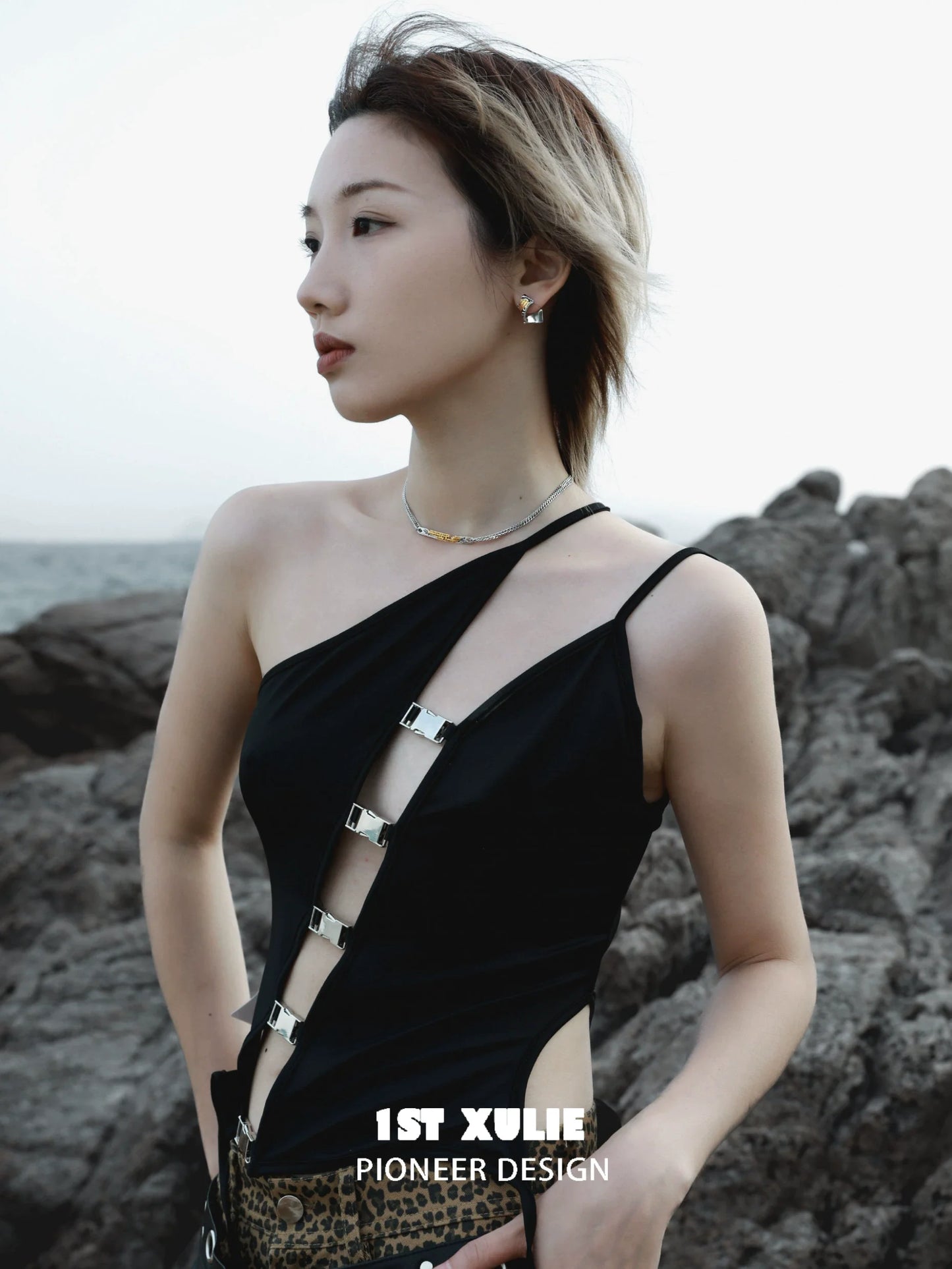 Elegant gold map earrings for women showcased in a stylish outdoor setting