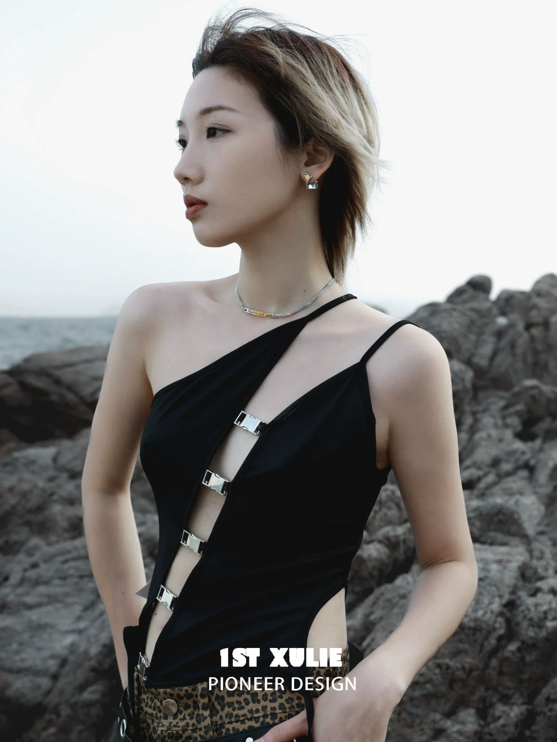 Elegant gold map earrings for women showcased in a stylish outdoor setting