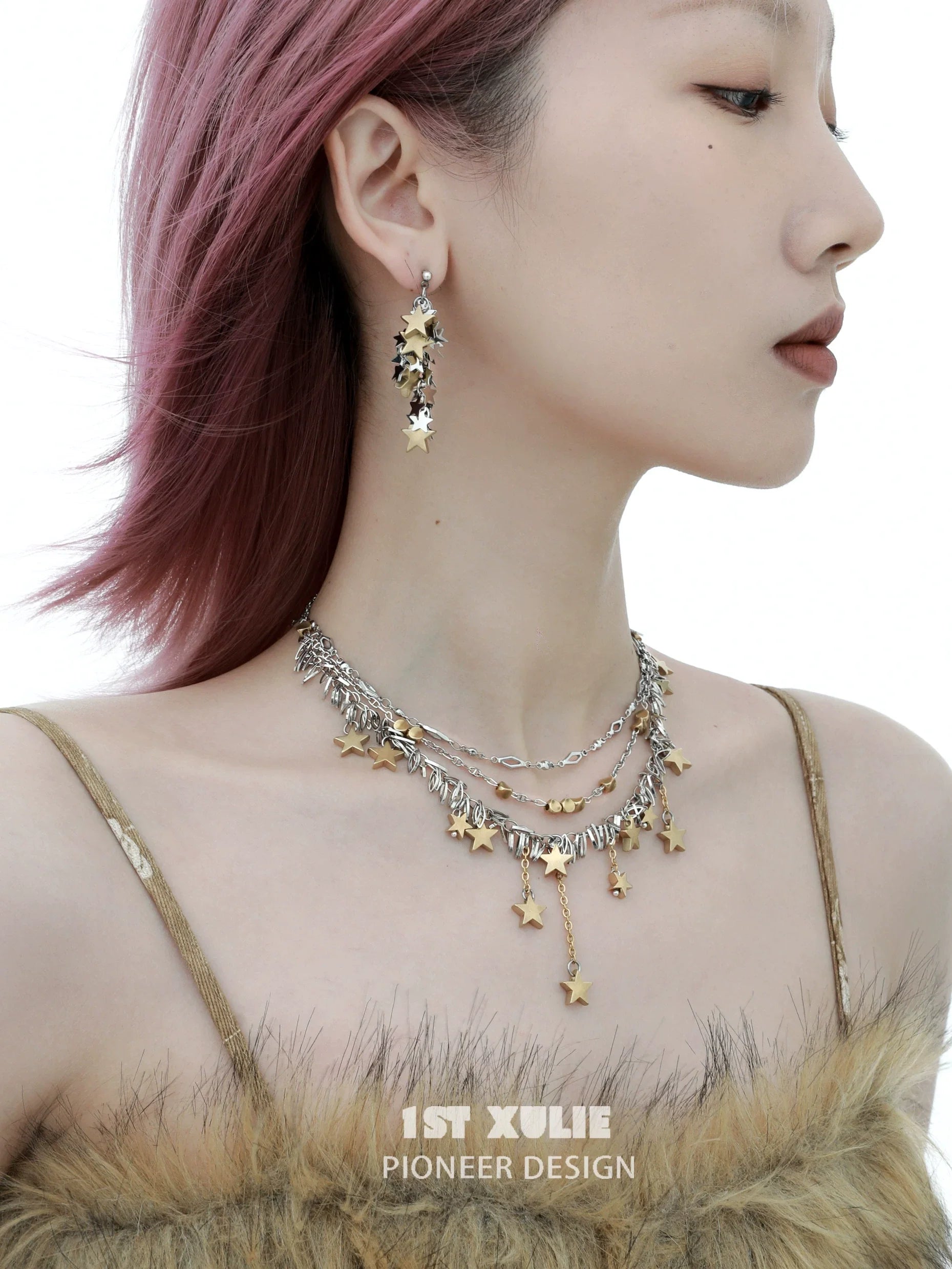 Gold star tassel necklace layered with silver accents, perfect for stylish accessorizing