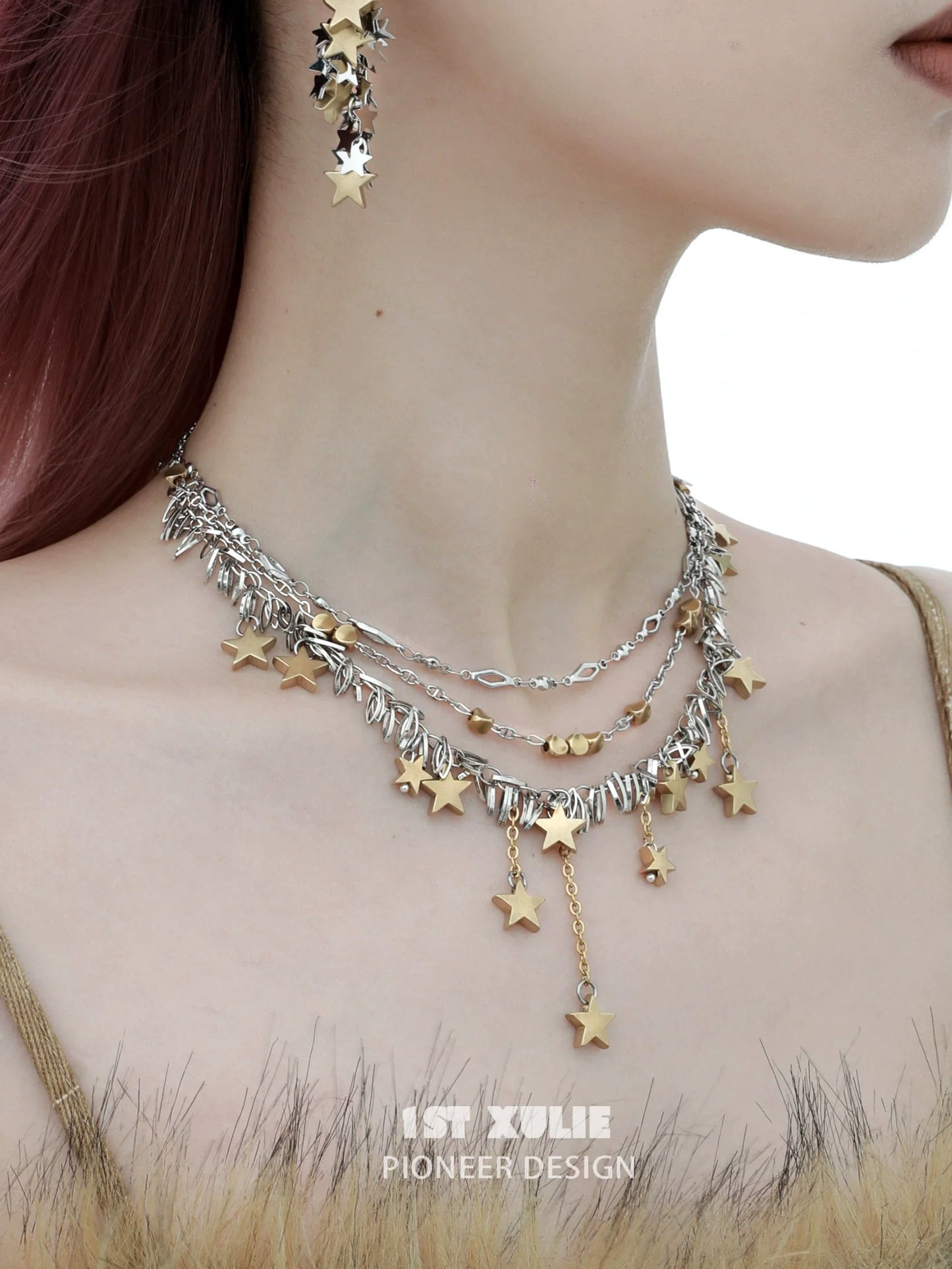 Gold star tassel necklace layered with silver chains and charms for a trendy look