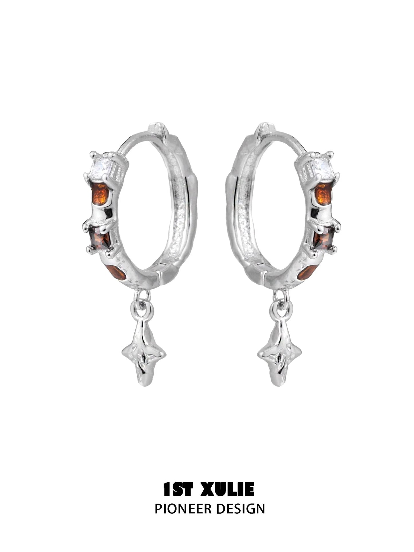 Silver hoop earrings with golden zircon accents and dangling star charms for a stylish look