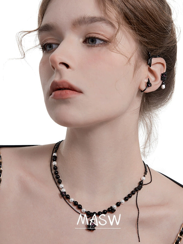 Model wearing MASW jewelry gothic ghost dangle earrings from Gothhalo Jewelry with a stylish outfit