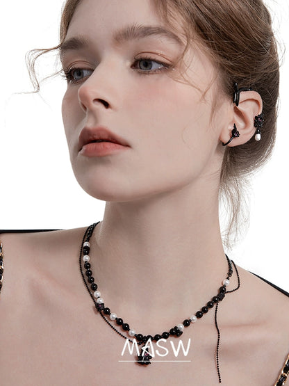 Model wearing MASW jewelry gothic ghost dangle earrings from Gothhalo Jewelry with a stylish outfit