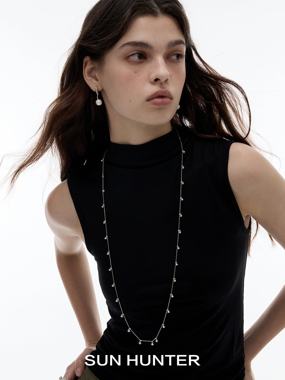 Sun Hunter jewelry golden bell pendant necklace for women from Gothhalo Jewelry worn by a model with a stylish look.