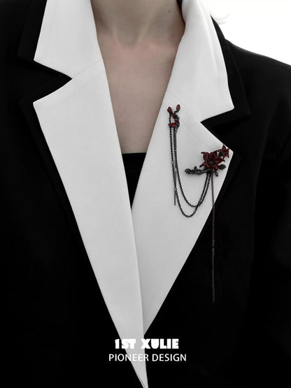 Gothic blood mandala brooch with intricate design, stylishly worn on a black and white blazer