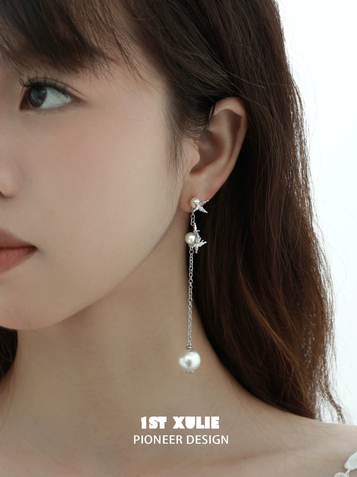 Stylish gothic butterfly earrings featuring pearl accents and hanging chain design
