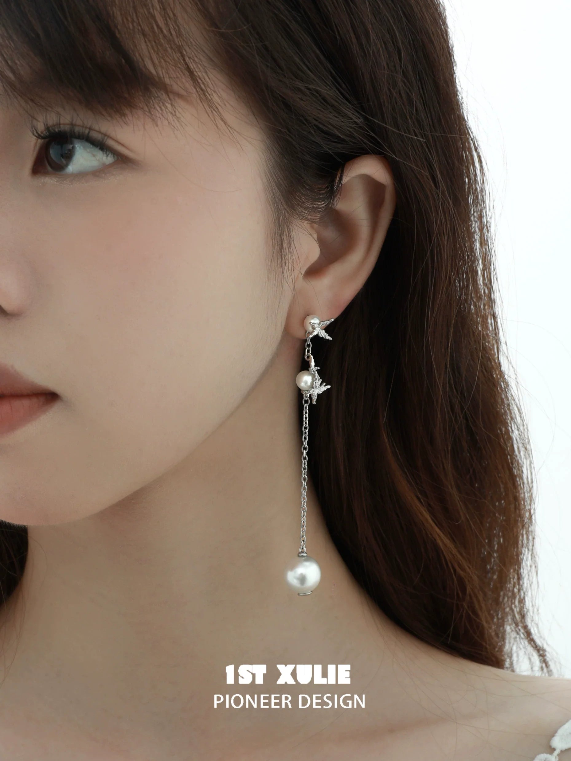 Stylish gothic butterfly earrings featuring pearl accents and hanging chain design