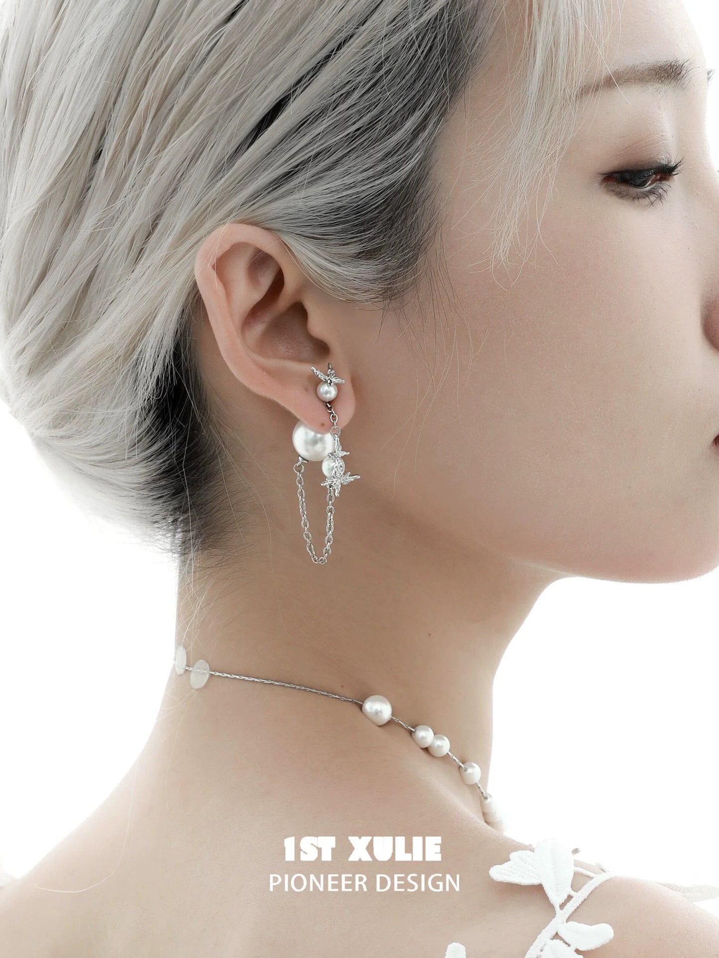 Gothic butterfly earrings featuring pearls and chains, styled for a trendy look