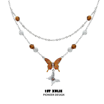 Gothic butterfly necklace featuring intricate design and orange accents for a striking look
