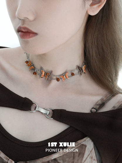 Gothic butterfly necklace adorned with orange gemstones on a silver chain for a trendy look