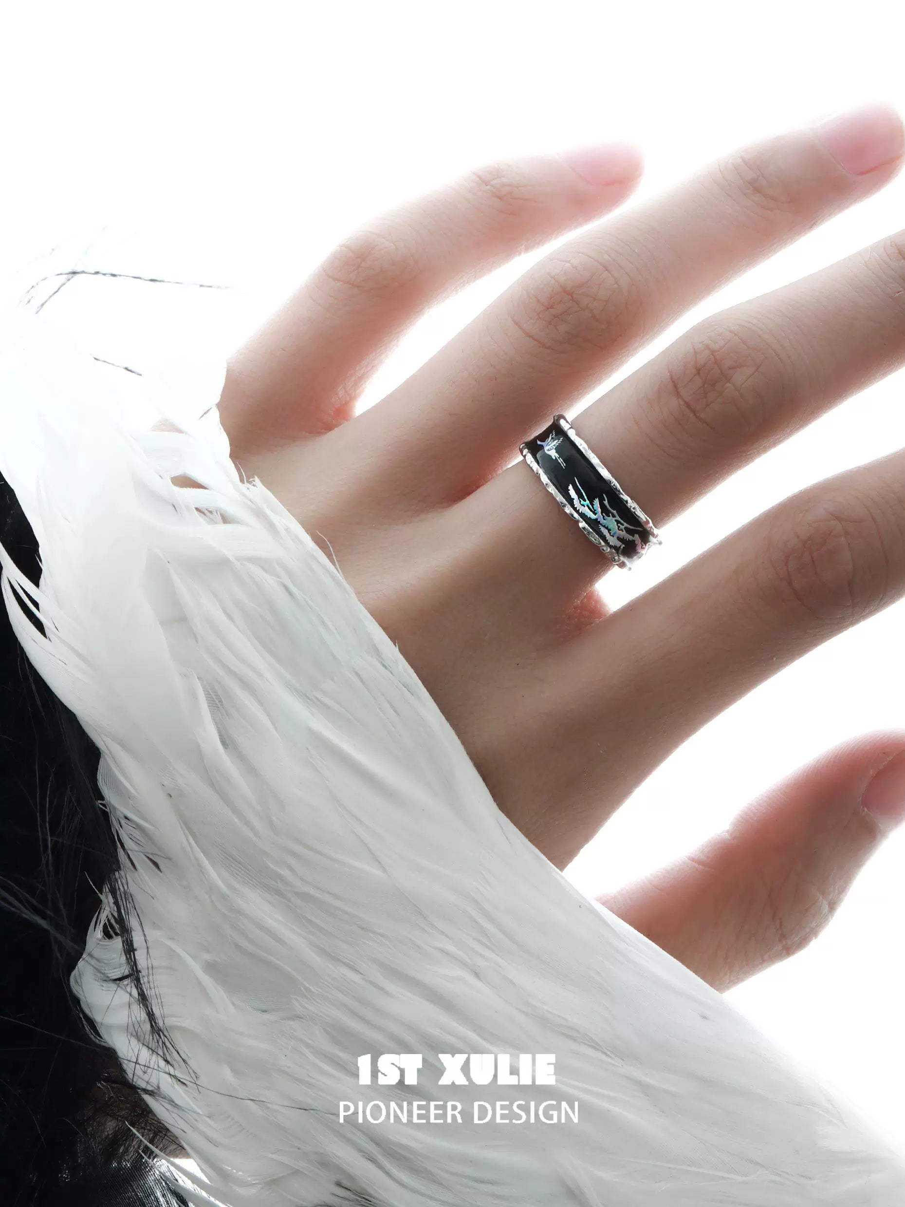 Stylish gothic crane silver ring worn on a hand with a feathered sleeve for a trendy look