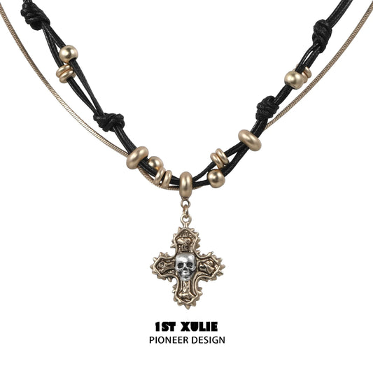 Gothic cross necklace by 1STXULIE featuring a unique skull pendant and intricate bead details
