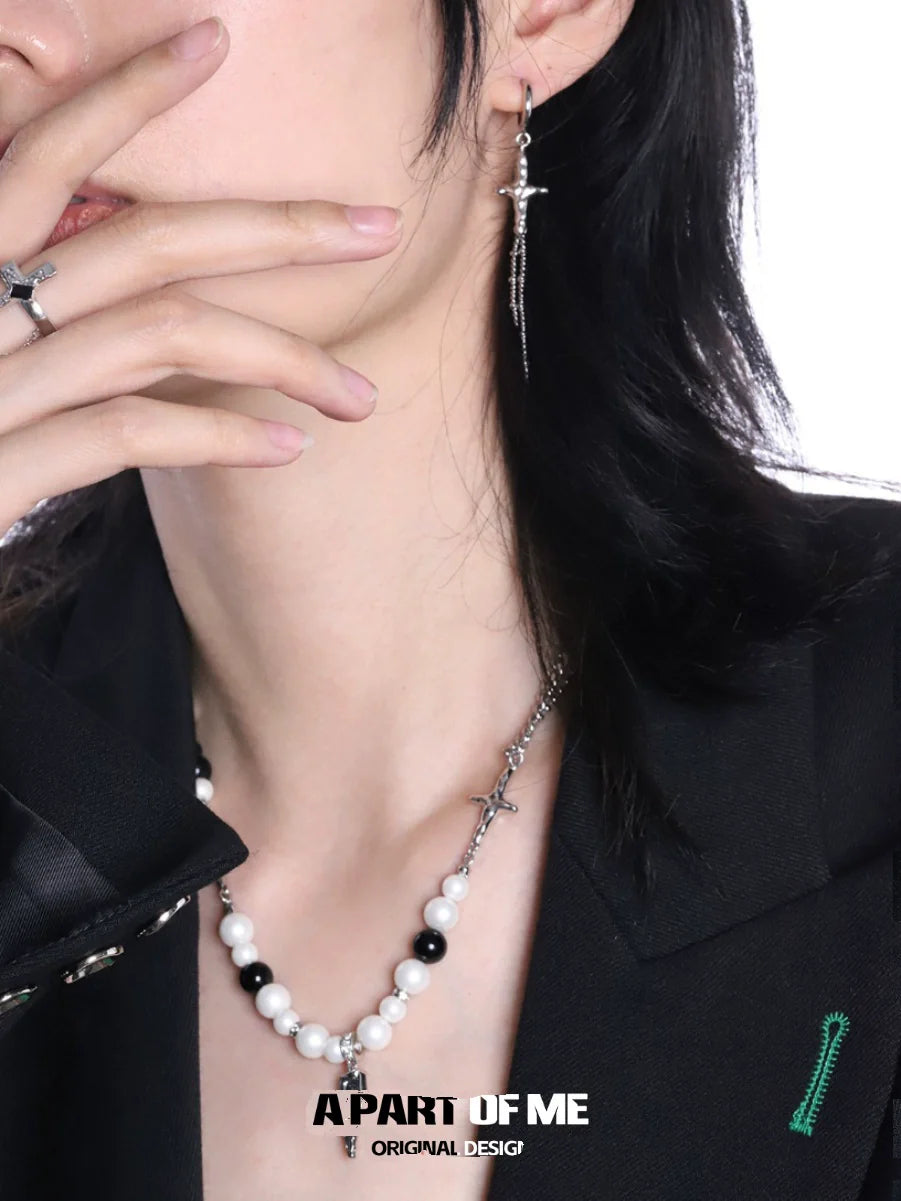 Stylish gothic cross ring for women paired with a black and white beaded necklace and cross earrings
