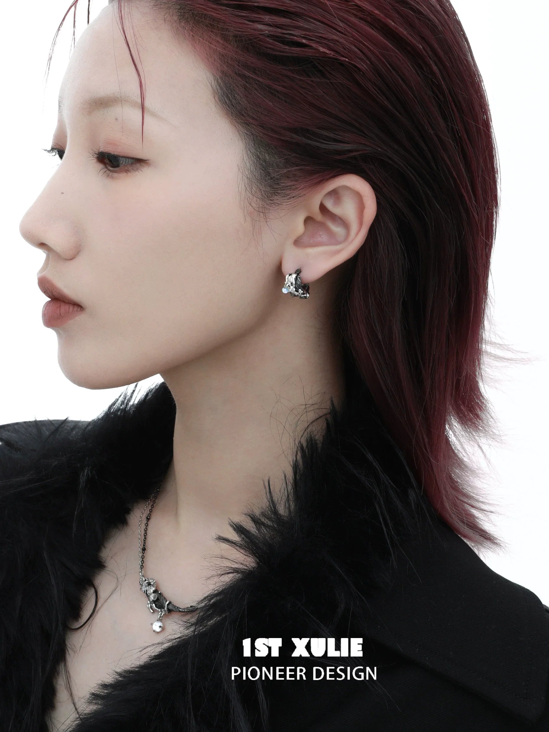 Gothic demon feather earrings by 1STXULIE showcased on a model with a stylish look