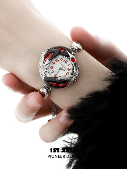 Gothic feather bracelet with a unique clock design featuring red accents and intricate details