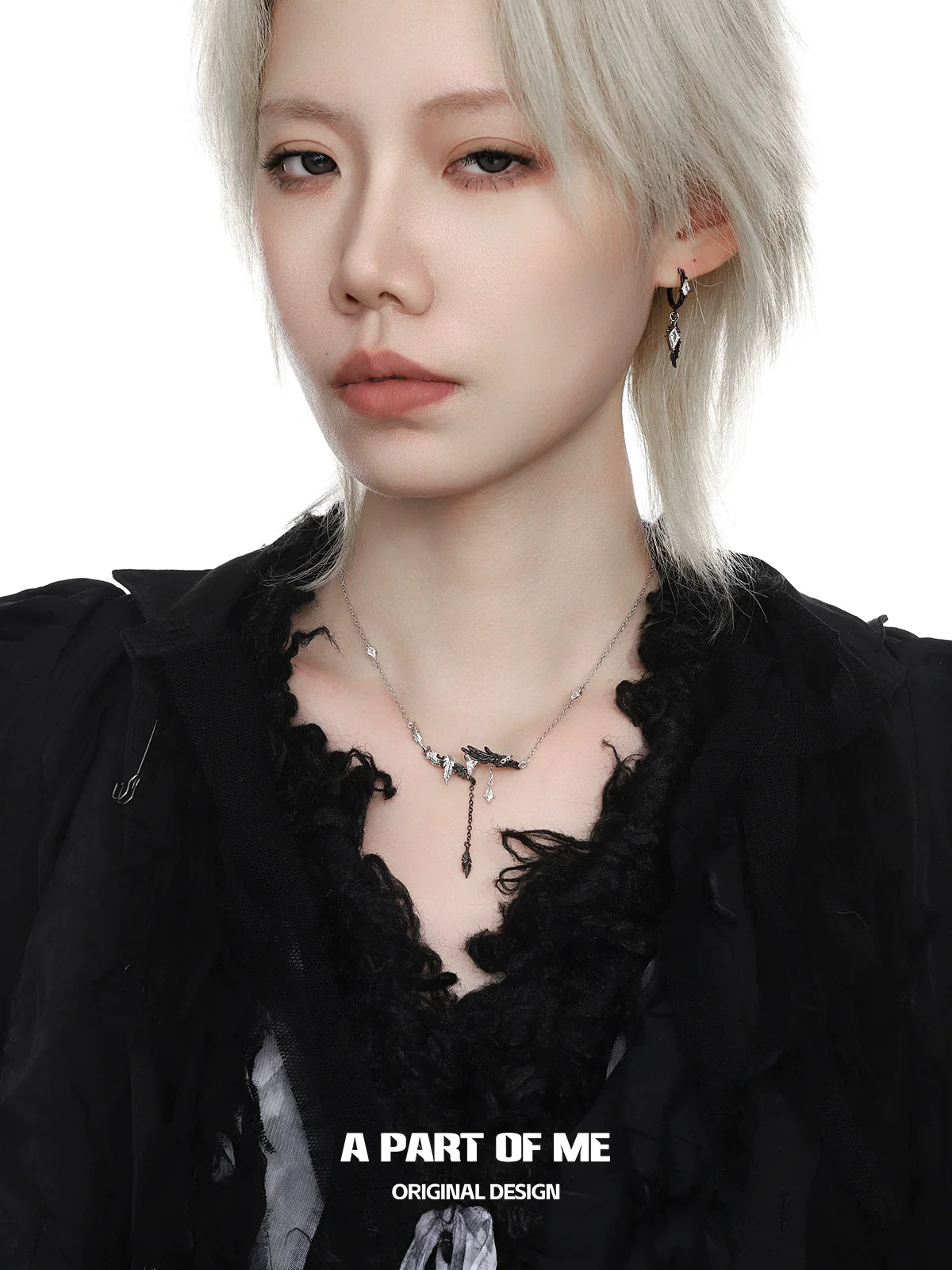 A model wearing a gothic feather necklace featuring intricate silver detailing and a stylish design