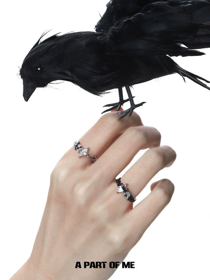 Gothic feather ring showcased on a hand with a raven, perfect for dark-themed jewelry lovers