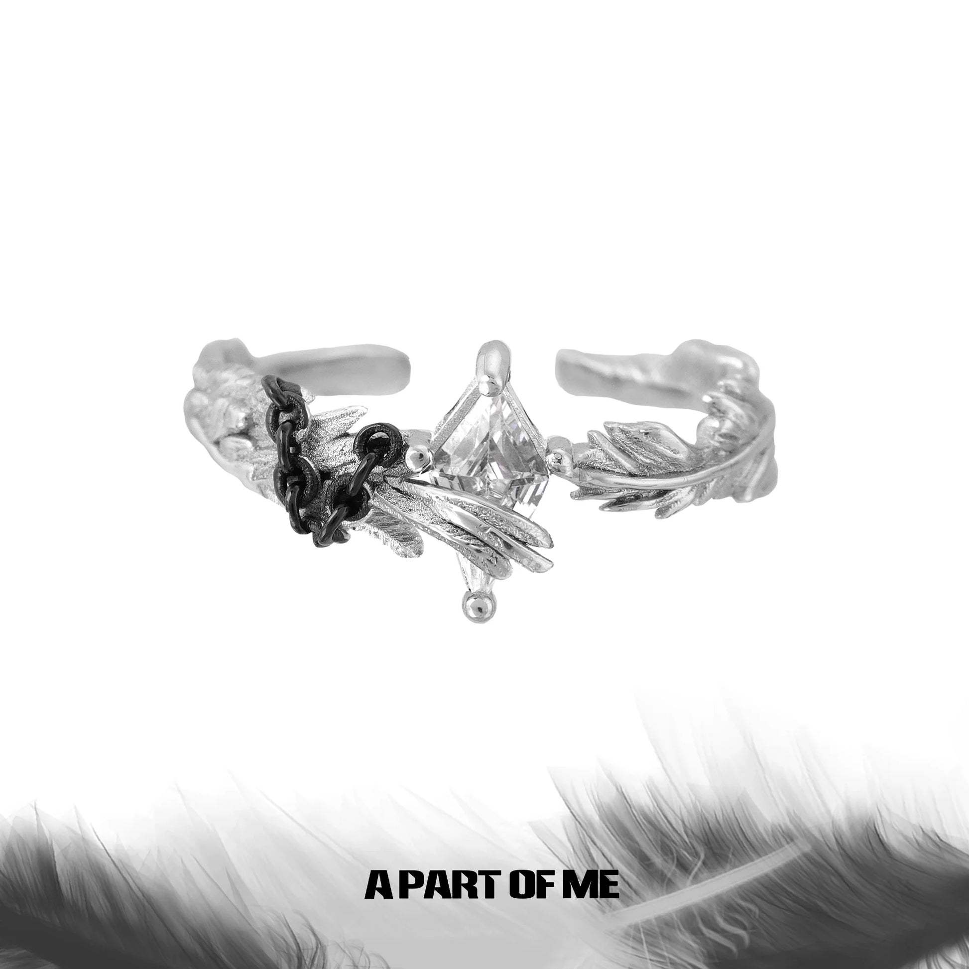A gothic feather ring featuring intricate feather designs and a sparkling stone centerpiece